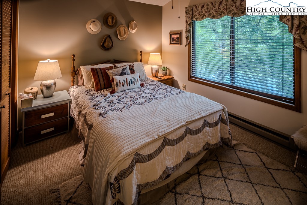 102 Spring Branch Road, Unit E Beech Mountain, NC 28604 - Photo 32 of 40 a bedroom with a bed and a window