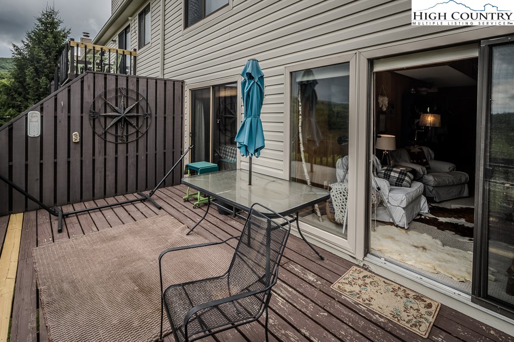 102 Spring Branch Road, Unit E Beech Mountain, NC 28604 - Photo 33 of 40 a view of a backyard with a patio and wooden fence