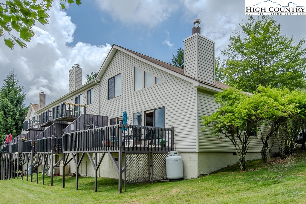 102 Spring Branch Road, Unit E Beech Mountain, NC 28604 - Photo 37 of 40 a view of a house with a yard