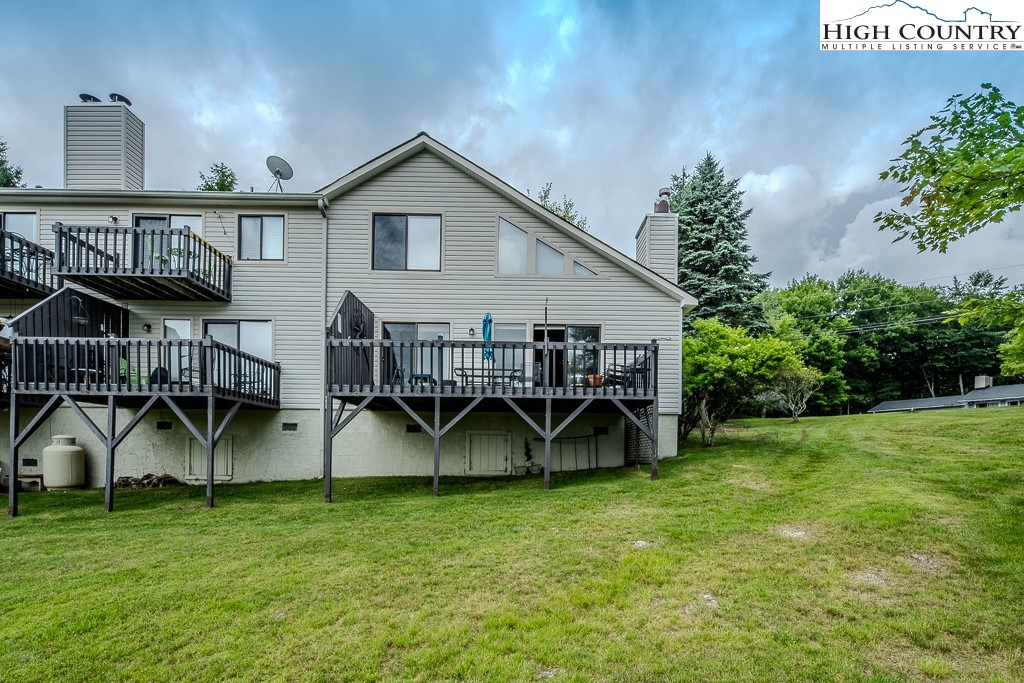 102 Spring Branch Road, Unit E Beech Mountain, NC 28604 - Photo 39 of 40 a view of an house with backyard space and garden