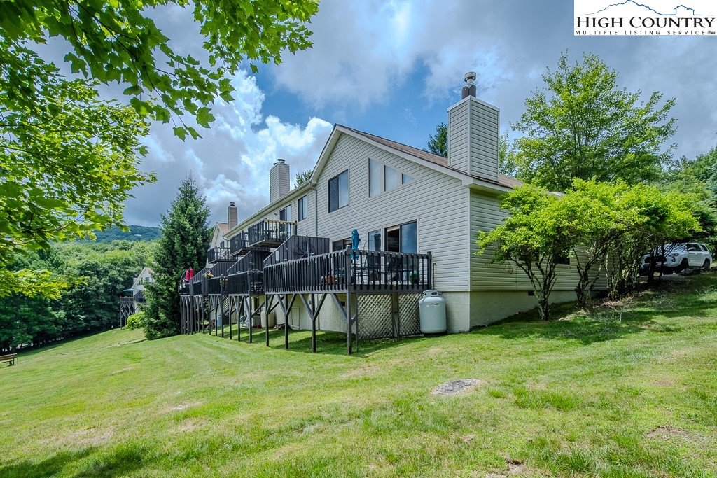 102 Spring Branch Road, Unit E Beech Mountain, NC 28604 - Photo 40 of 40 a view of a house with a yard and sitting area