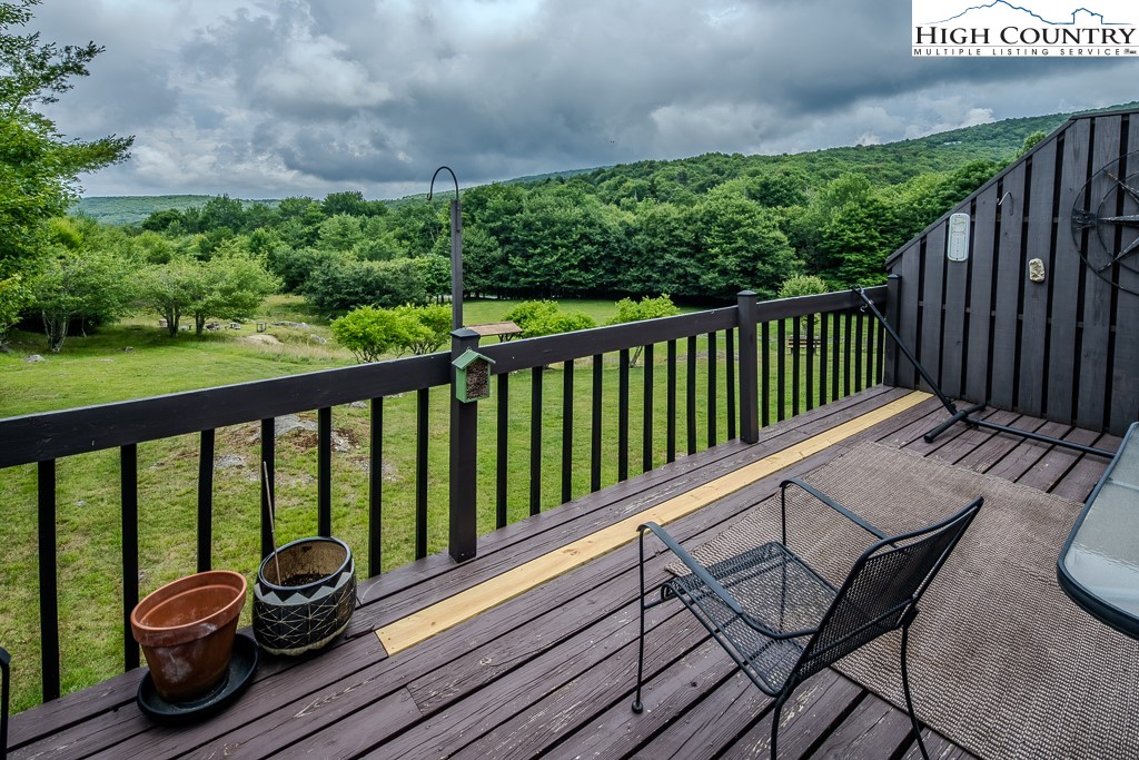 102 Spring Branch Road, Unit E Beech Mountain, NC 28604 - Photo 6 of 40 a view of a balcony with wooden floor