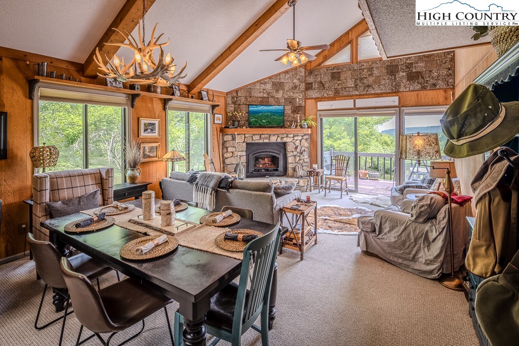 102 Spring Branch Road, Unit E Beech Mountain, NC 28604 - Photo 10 of 40 a dining room with furniture a chandelier and a rug