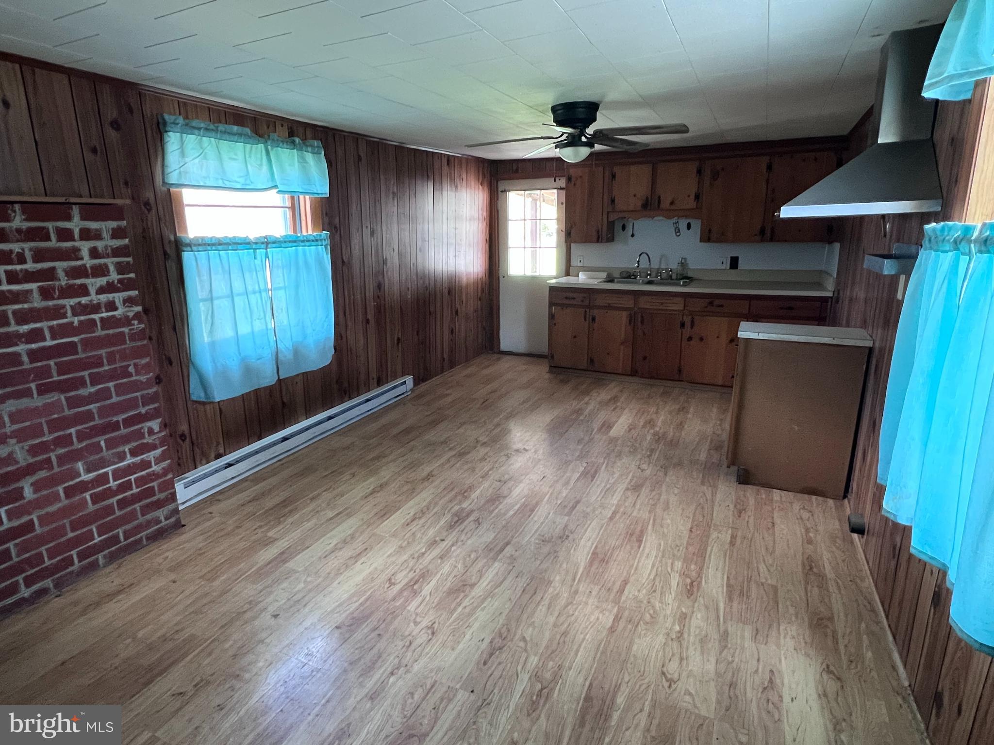12759 Main Street Fort Loudon, PA 17224 - Photo 11 of 18 a kitchen with stainless steel appliances granite countertop a refrigerator a sink dishwasher a stove and white countertops with wooden floor