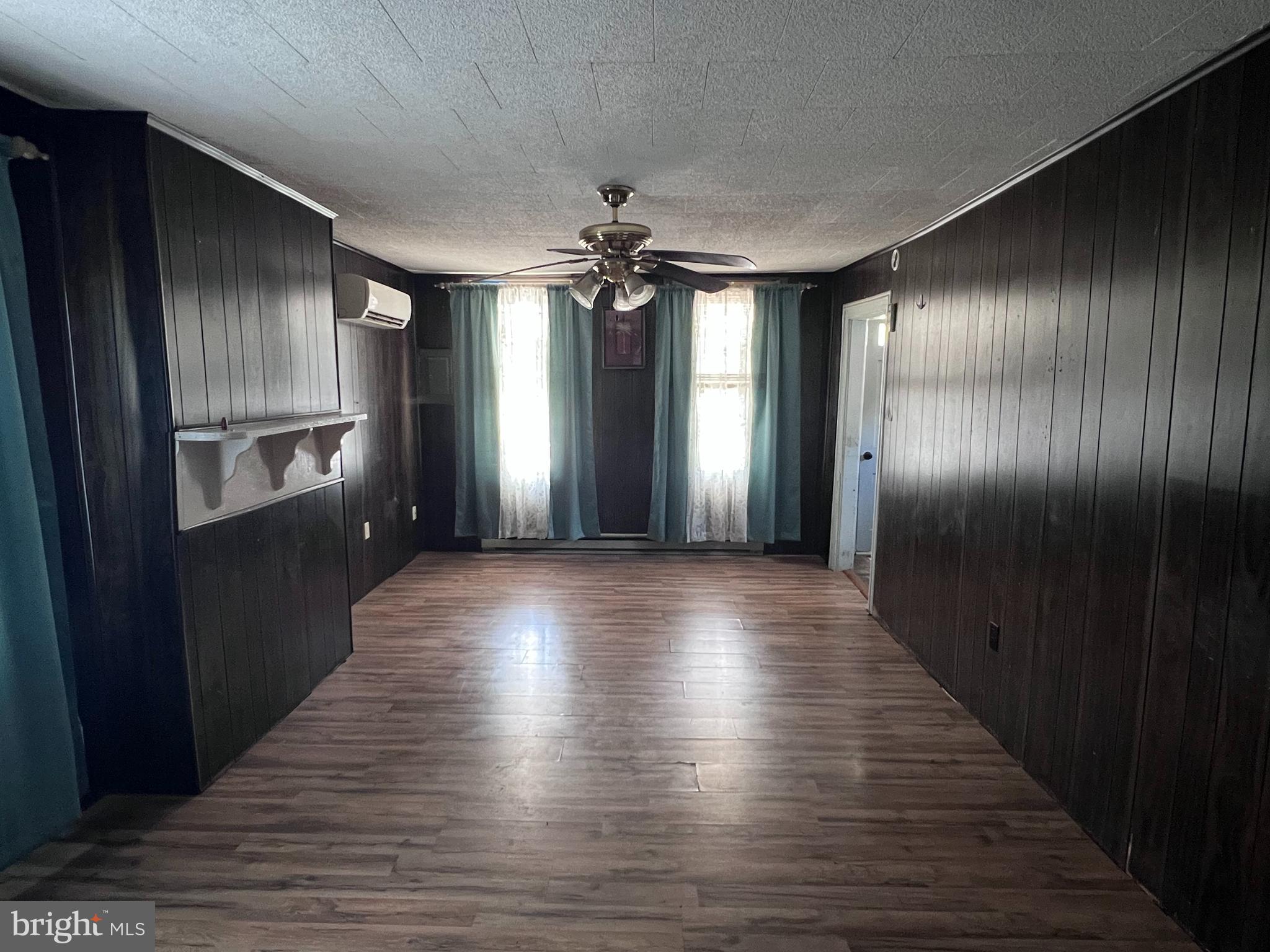 12759 Main Street Fort Loudon, PA 17224 - Photo 6 of 18 an empty room with wooden floor chandelier and windows