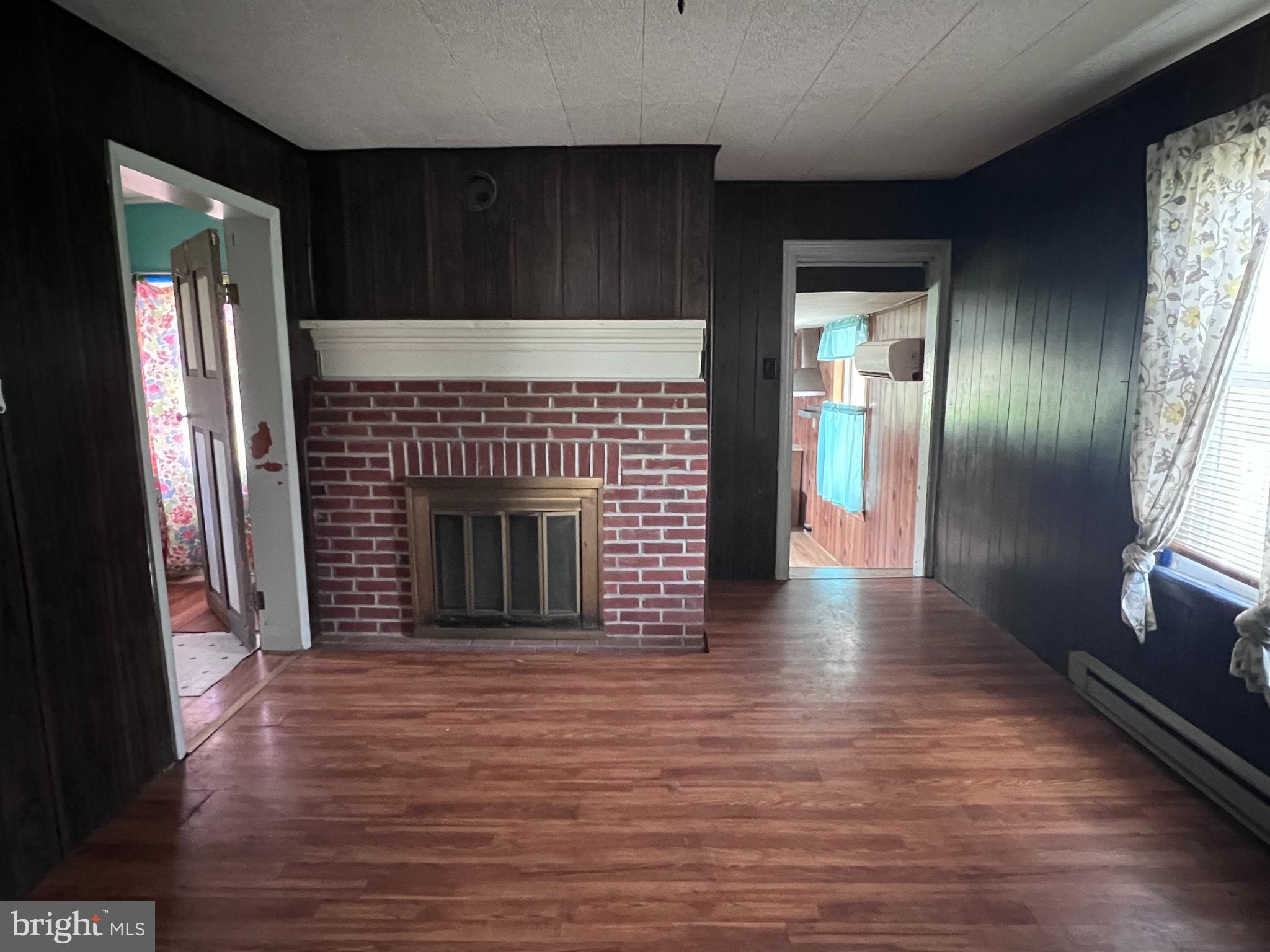 12759 Main Street Fort Loudon, PA 17224 - Photo 8 of 18 a view of a hallway with wooden floor and a fireplace