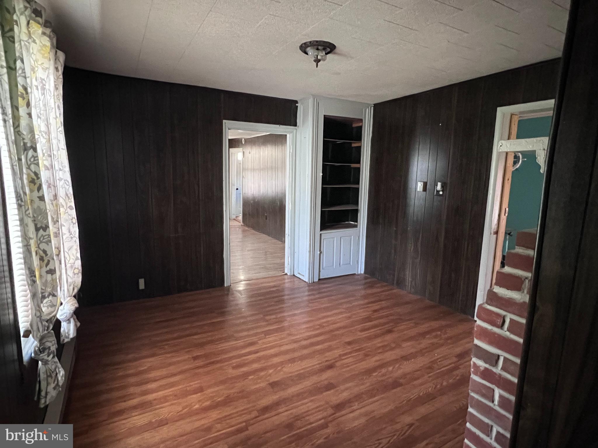12759 Main Street Fort Loudon, PA 17224 - Photo 9 of 18 a view of an empty room with wooden floor and a window