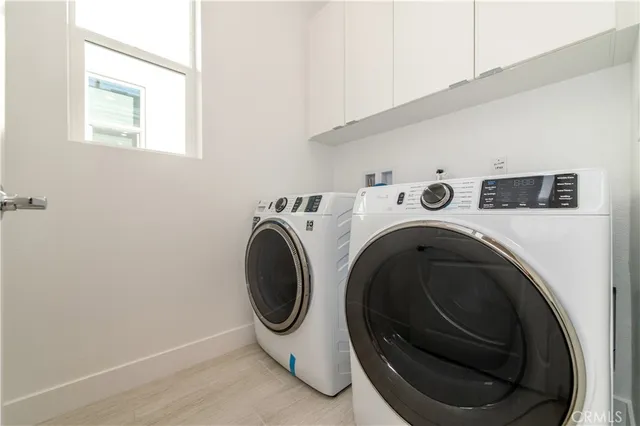 an empty room with windows and entrance to other room