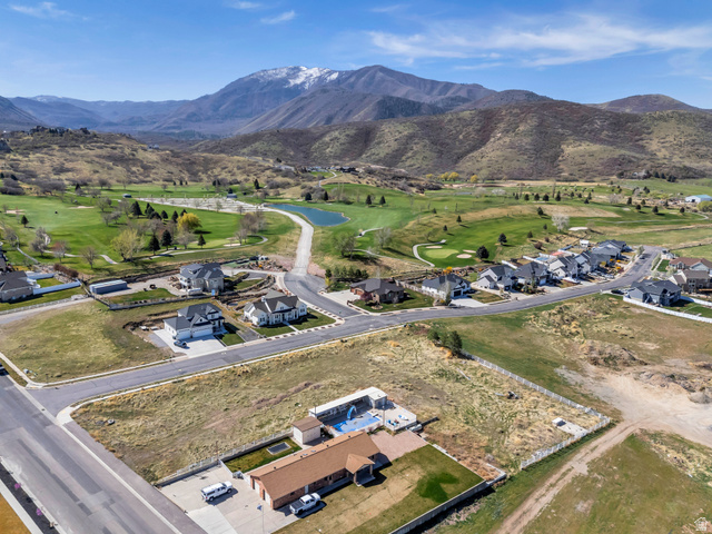 296 West Olympic Lane, Unit 2 Elk Ridge, UT 84651 - Photo 3 of 14 Aerial view of residential area with a local golf course and mountains