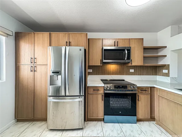 a kitchen with a refrigerator stove and microwave