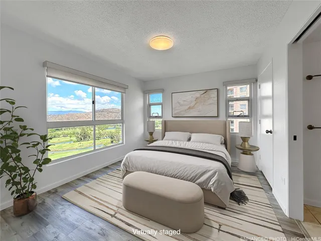 a bedroom with a bed and a large window