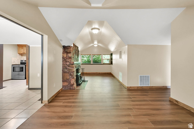 655 Ogden Canyon Road Ogden, UT 84401 - Photo 50 of 50 Spacious living area featuring wood-finish flooring, a stone fireplace, and multiple windows providing natural light