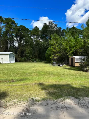 a view of a pool with a yard