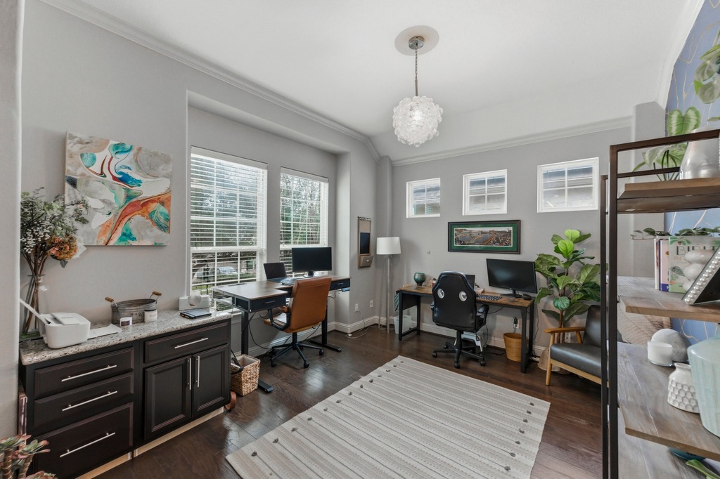 5425 Cherokee Draw Road Austin, TX 78738 - Photo 17 of 40 An inviting home office boasts rich hardwood floors and multiple large windows, ideal for productivity.