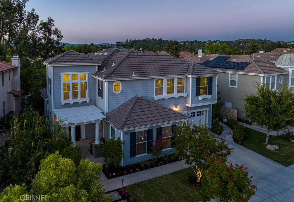 23915 Lakeside Road Valencia, CA 91355 - Photo 2 of 74 a view of a big house with a big yard and potted plants