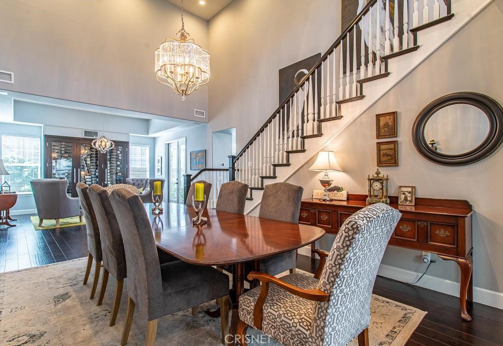 23915 Lakeside Road Valencia, CA 91355 - Photo 22 of 74 a dining room with furniture a rug and wooden floor