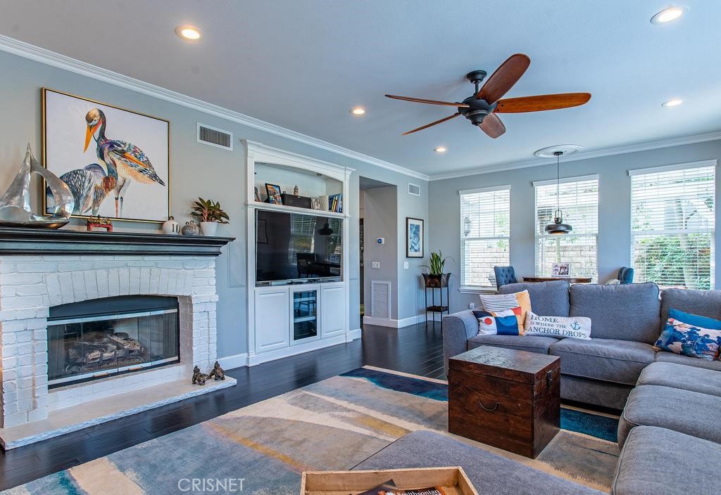 23915 Lakeside Road Valencia, CA 91355 - Photo 23 of 74 a living room with furniture a flat screen tv and a fireplace