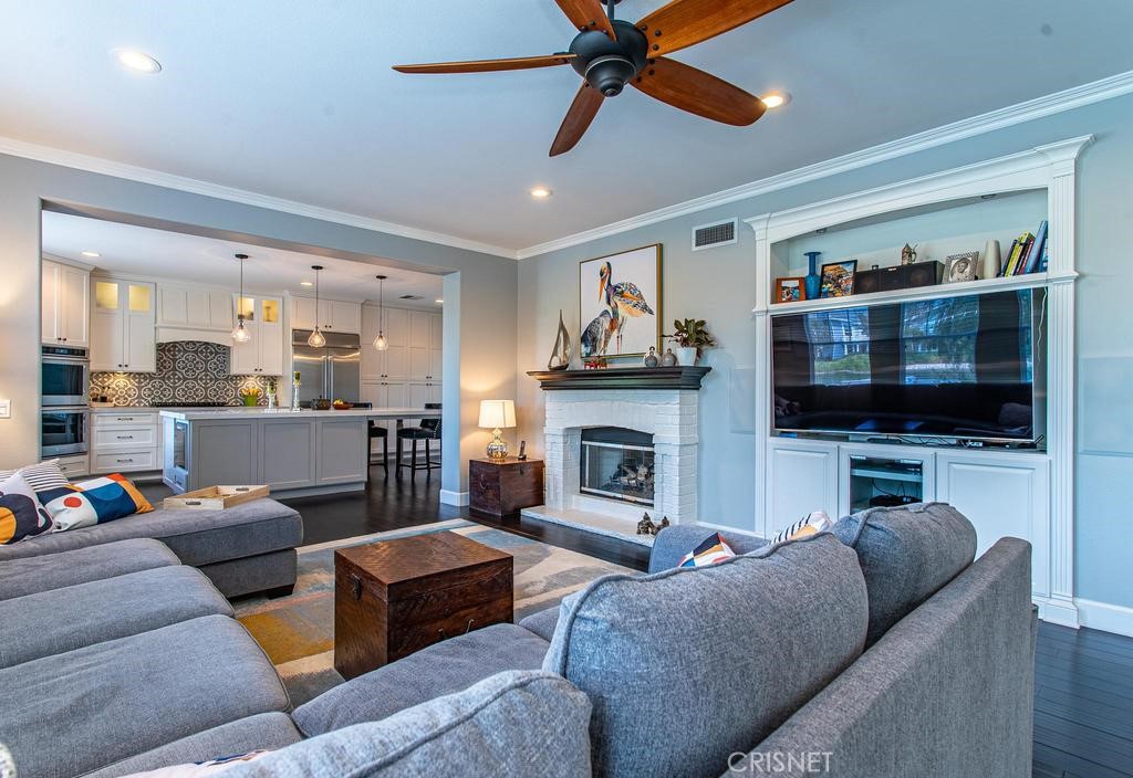 23915 Lakeside Road Valencia, CA 91355 - Photo 25 of 74 a living room with furniture a flat screen tv and a fireplace
