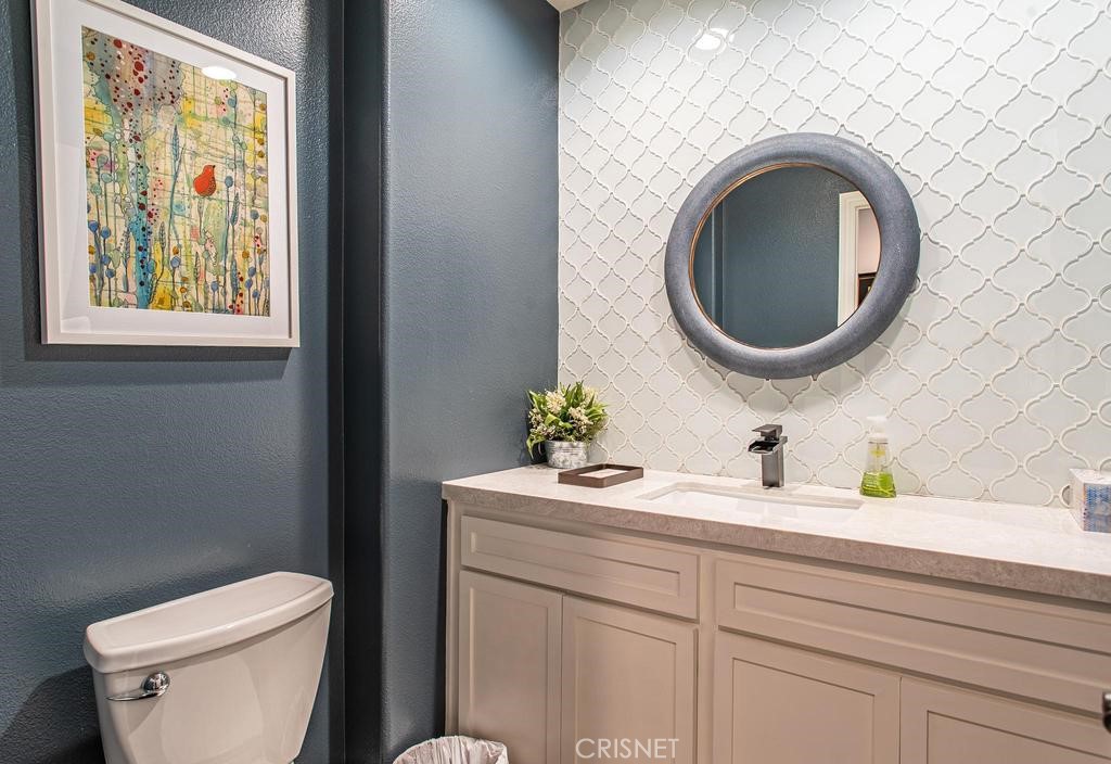23915 Lakeside Road Valencia, CA 91355 - Photo 32 of 74 a bathroom with a toilet a sink and a mirror