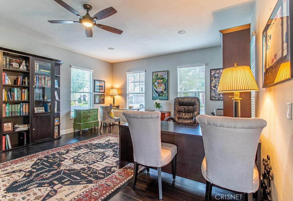 23915 Lakeside Road Valencia, CA 91355 - Photo 33 of 74 a living room with furniture a rug and a bookshelf