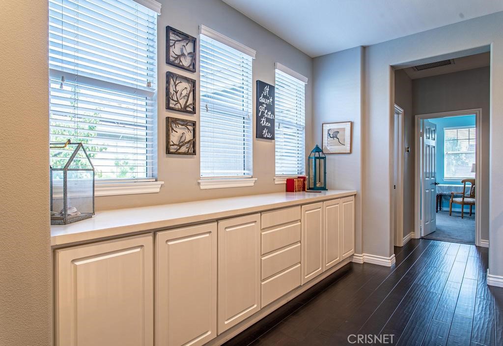 23915 Lakeside Road Valencia, CA 91355 - Photo 47 of 74 a kitchen with granite countertop white cabinets and white appliances
