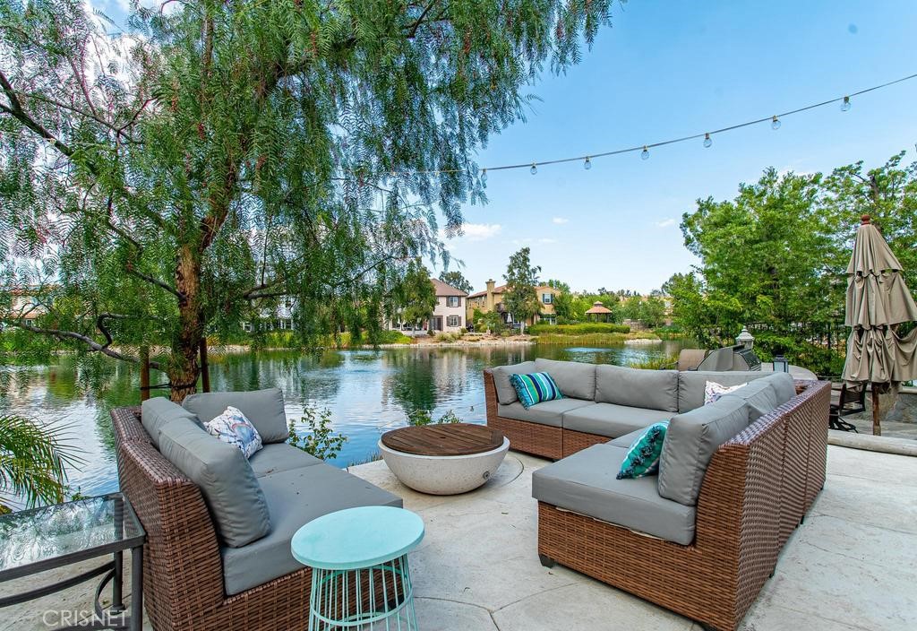 23915 Lakeside Road Valencia, CA 91355 - Photo 58 of 74 a view of a patio with couches chairs and a fire pit