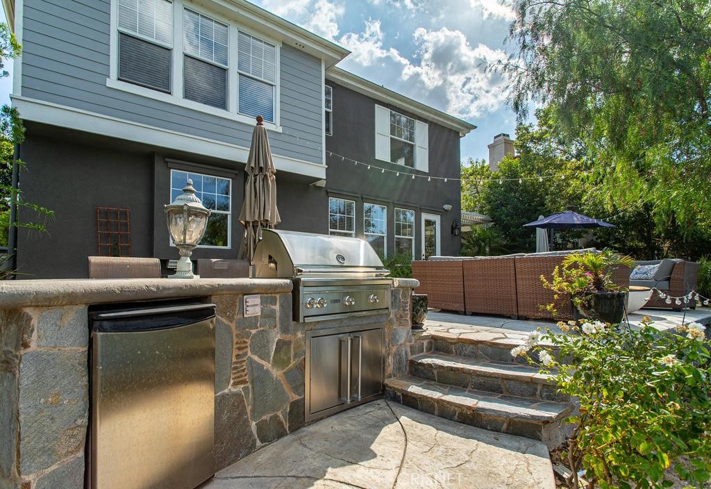 23915 Lakeside Road Valencia, CA 91355 - Photo 61 of 74 a view of a patio with table and chairs and potted plants