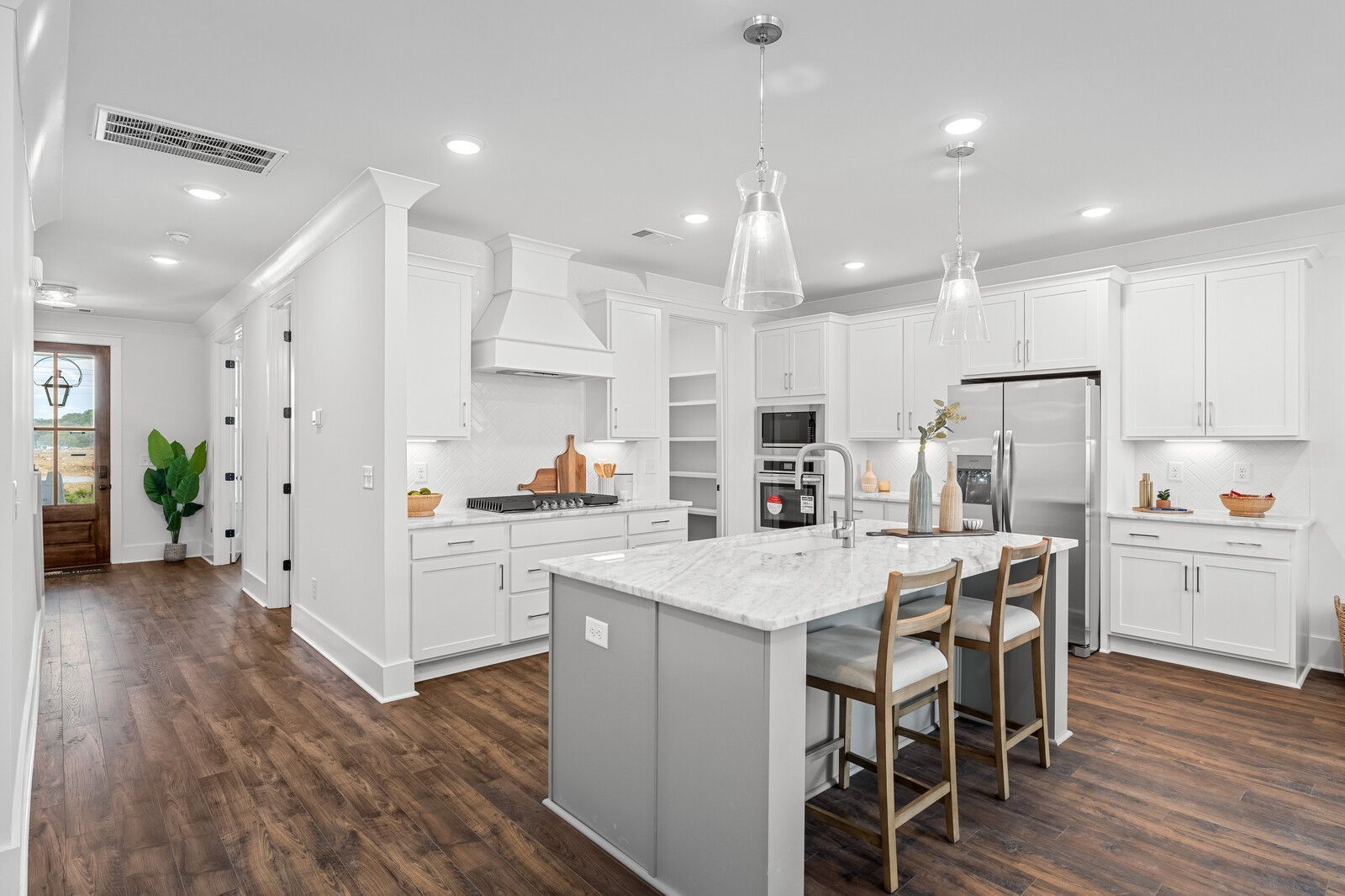 a kitchen with white cabinets and white stainless steel appliances