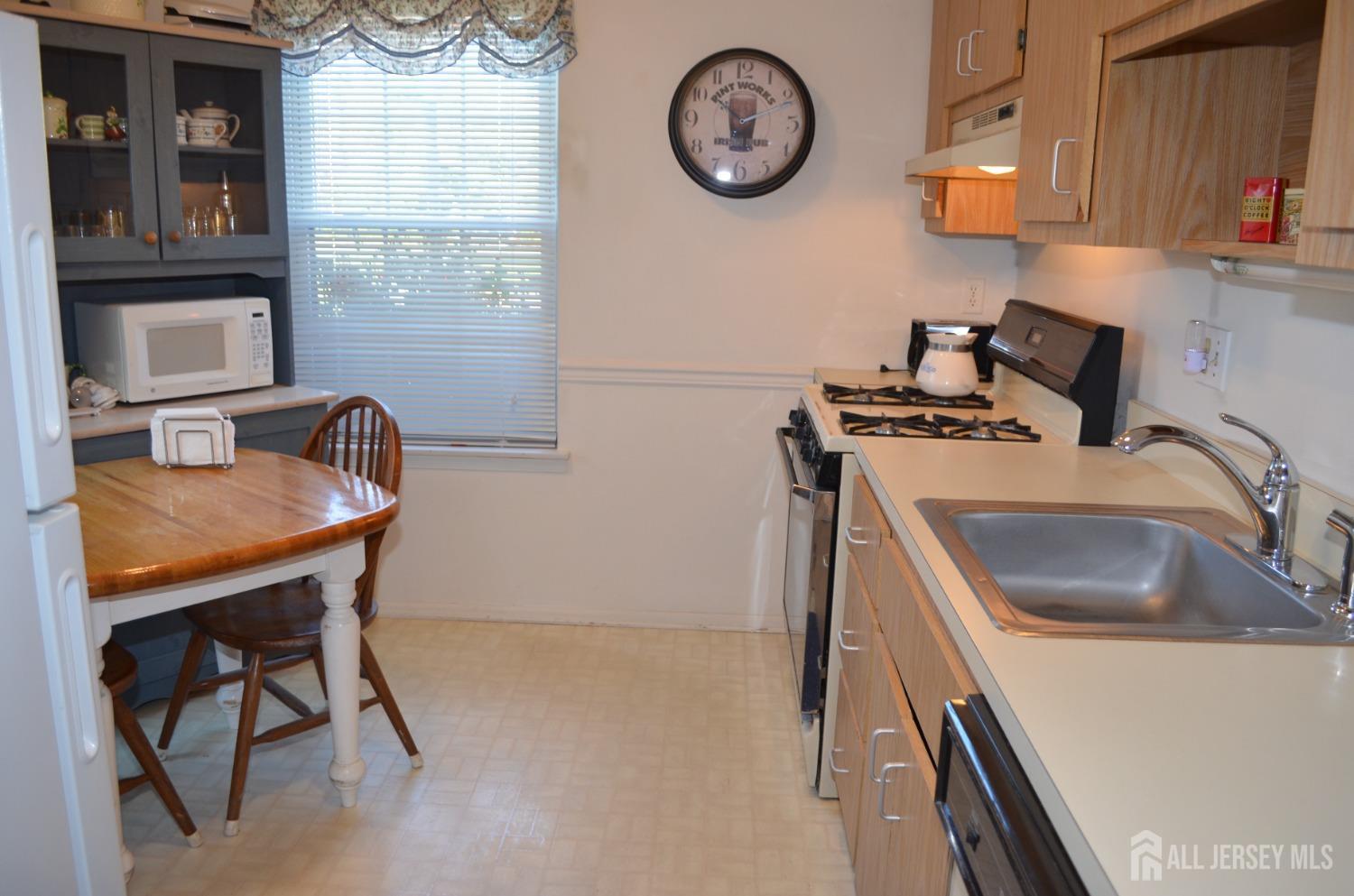 19 Foxhall Middlesex, NJ 08846 - Photo 8 of 21 a kitchen with a sink a stove and a refrigerator