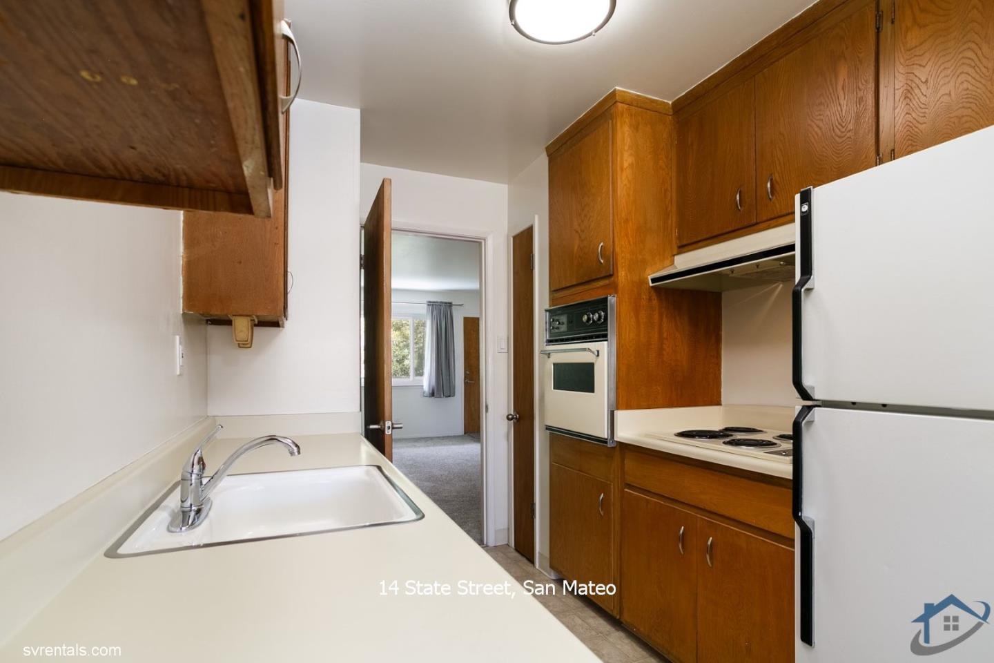 14 State Street, Unit 6 San Mateo, CA 94401 - Photo 11 of 20 a kitchen with a refrigerator and a sink
