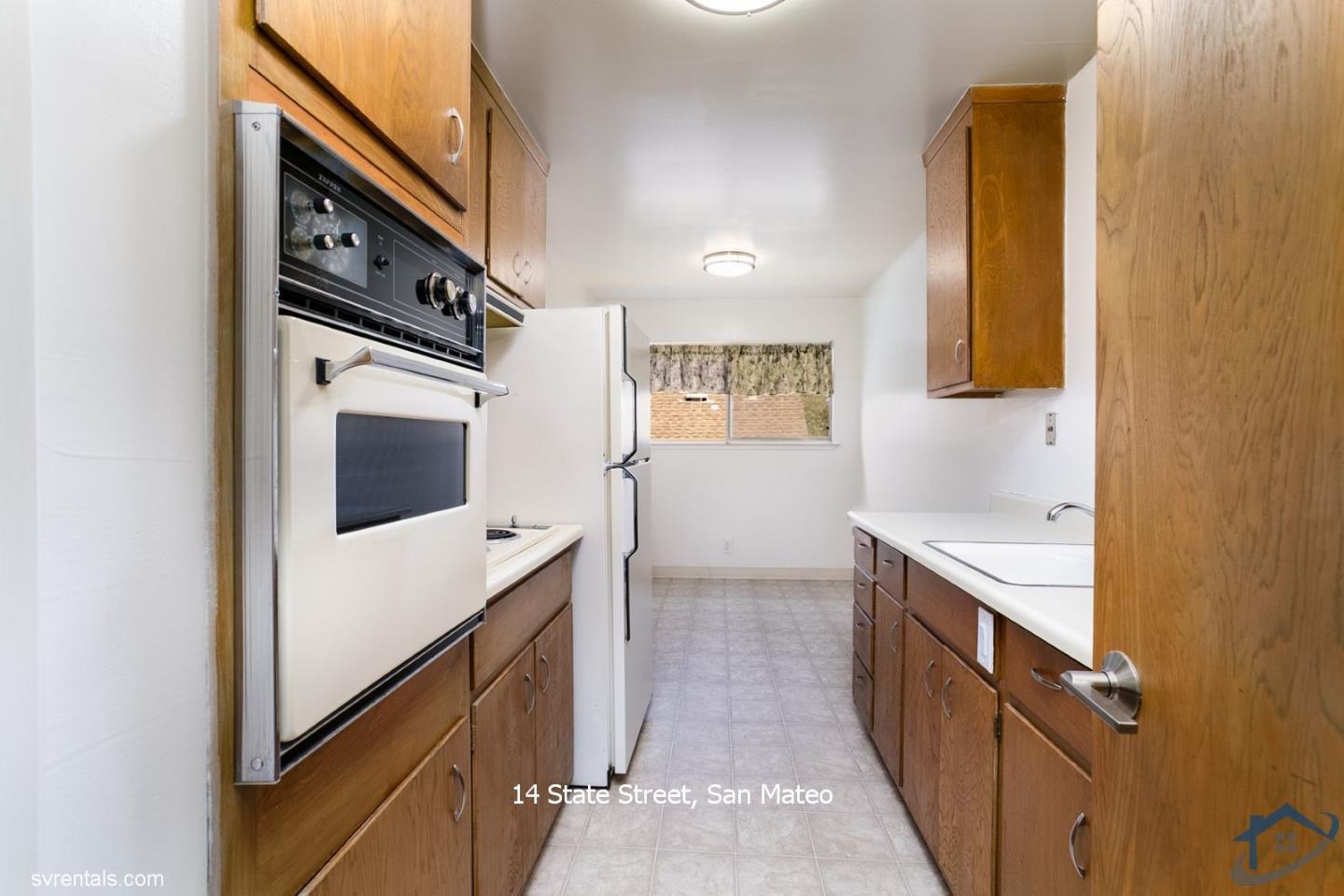 14 State Street, Unit 6 San Mateo, CA 94401 - Photo 7 of 20 a kitchen with stainless steel appliances granite countertop a washer and dryer