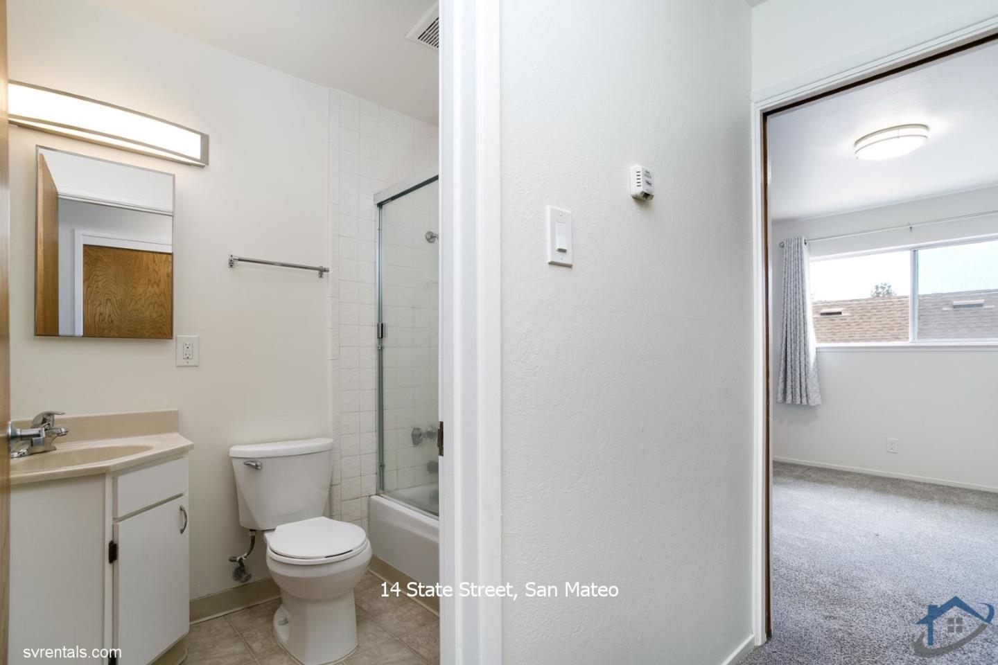 14 State Street, Unit 6 San Mateo, CA 94401 - Photo 8 of 20 a bathroom with a toilet a sink a vanity and mirror