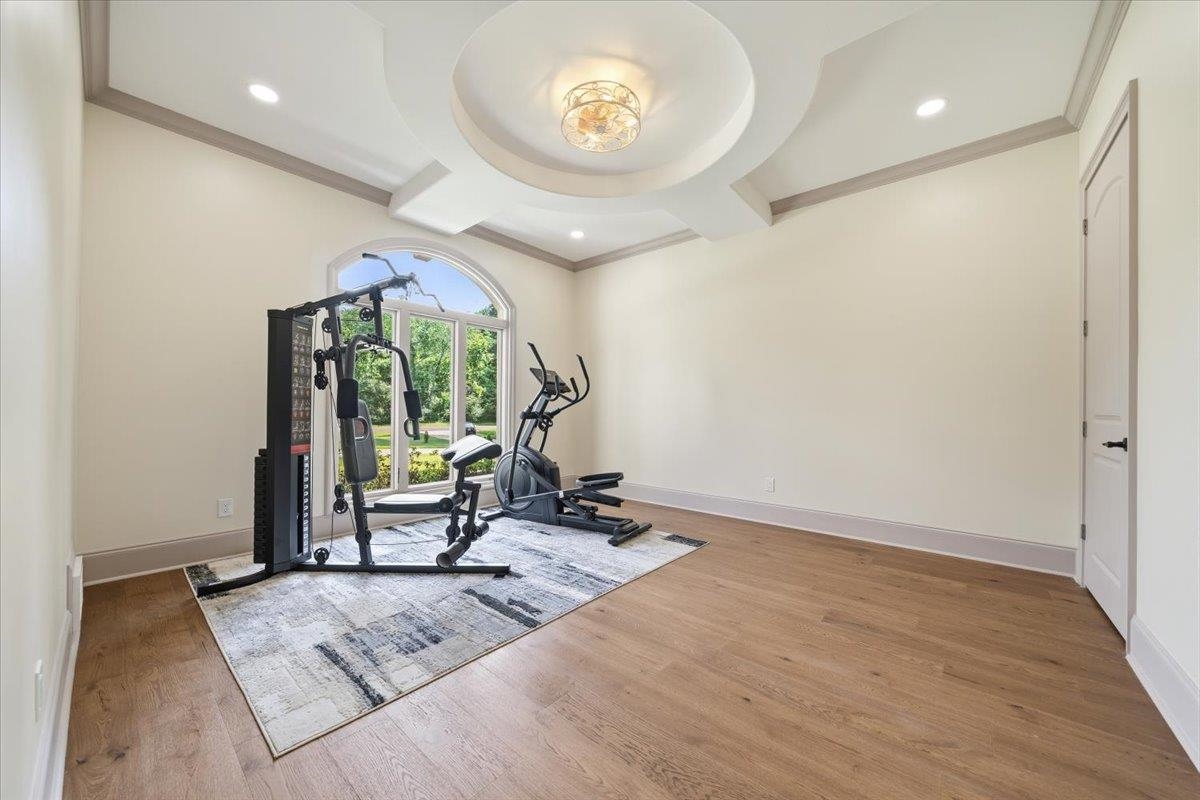 6060 Elmore Road Bartlett, TN 38134 - Photo 22 of 40 Room featuring a decorative tray ceiling with a central light fixture, recessed lighting, and wood-finish flooring