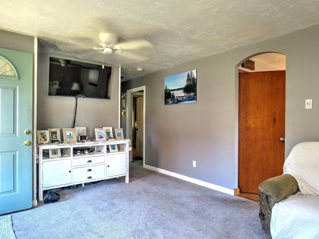 25 Foley Road Rockland, MA 02370 - Photo 6 of 19 a living room with furniture and a flat screen tv