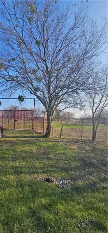 a view of a big yard with a house