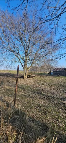 a view of yard with wooden fence