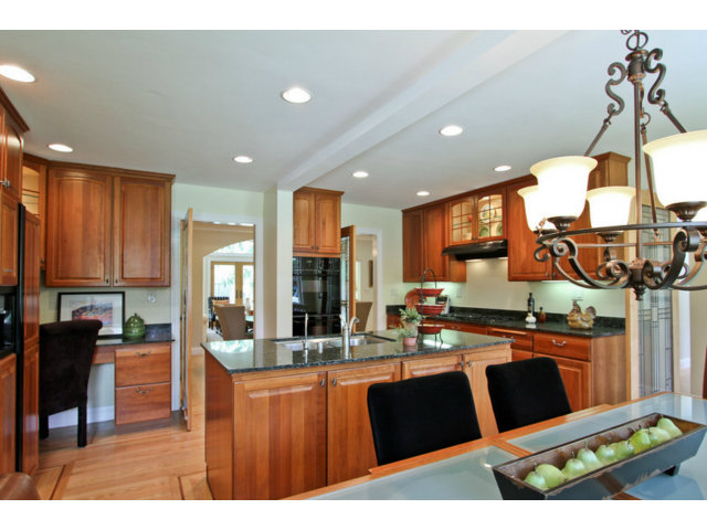 1761 Lantis Lane Los Altos, CA 94024 - Photo 6 of 19 a kitchen with stainless steel appliances kitchen island granite countertop a sink and a wooden cabinets
