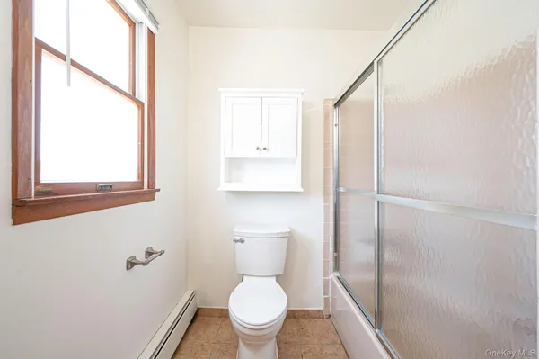 a white toilet sitting next to a bathroom sink