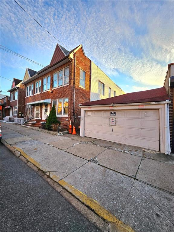 718 Bay Ridge Avenue Brooklyn, NY 11228 - Photo 1 of 6 a front view of a house with a yard and garage