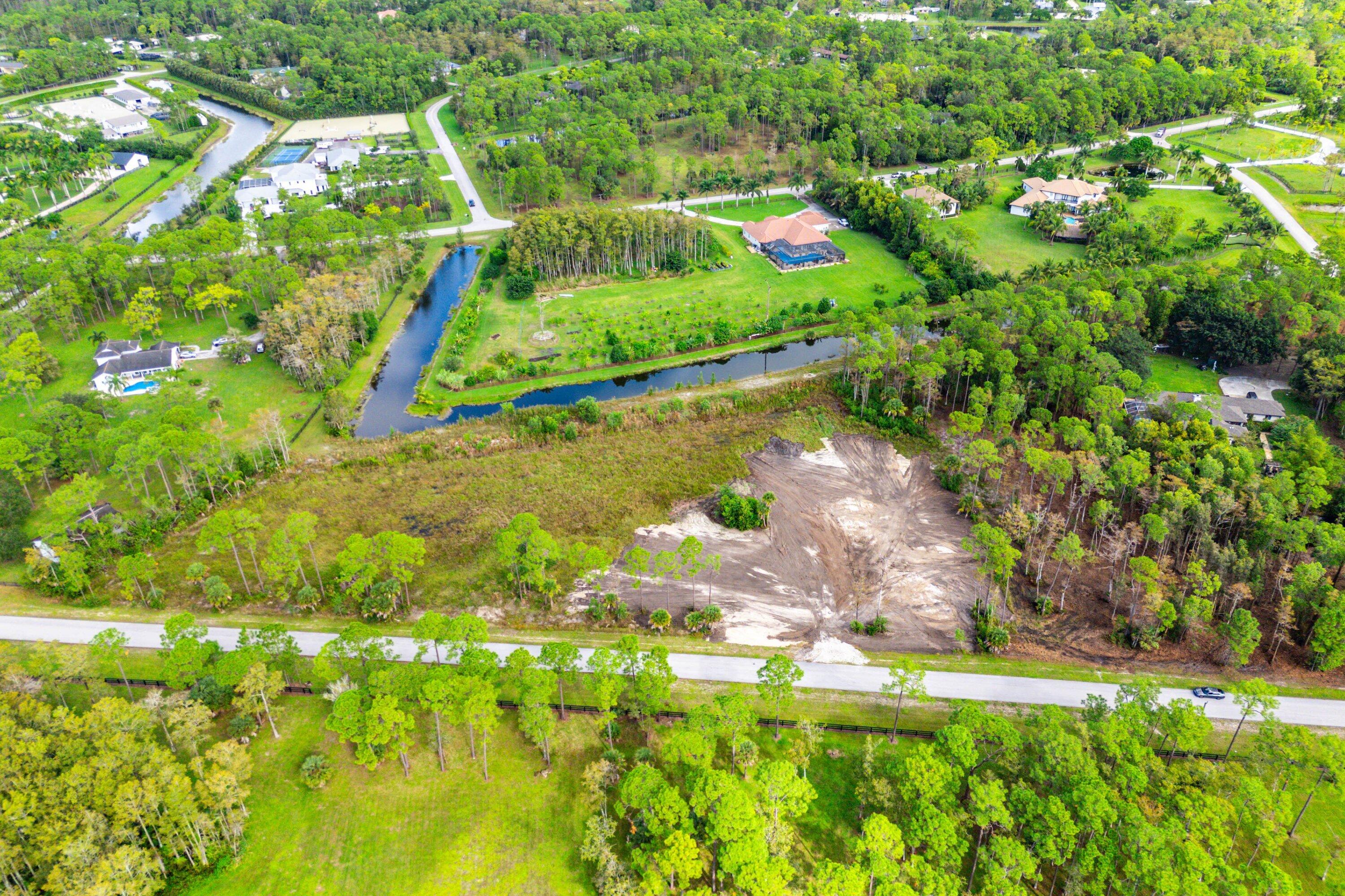6269 Wild Orchid Trail Lake Worth, FL 33449 - Photo 1 of 12 a view of a yard with plants and large trees