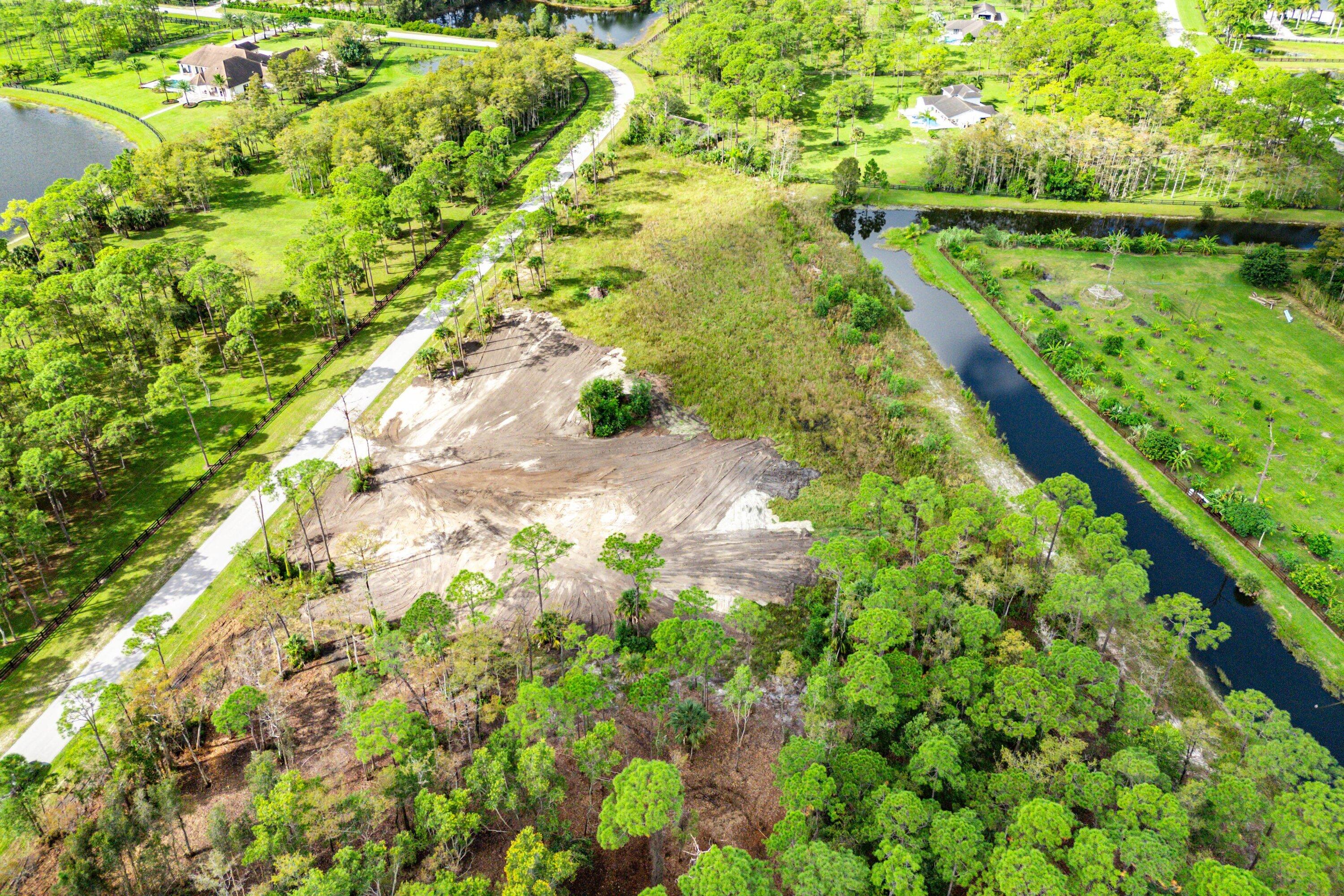 6269 Wild Orchid Trail Lake Worth, FL 33449 - Photo 8 of 12 a view of a lake with a yard