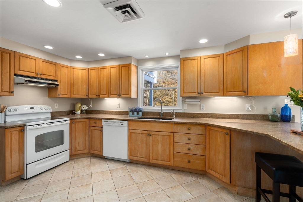 115 Victoria Road Sudbury, MA 01776 - Photo 11 of 41 a kitchen with granite countertop cabinets stainless steel appliances and a sink