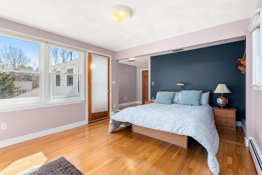 115 Victoria Road Sudbury, MA 01776 - Photo 21 of 41 a bedroom with a bed and a large window
