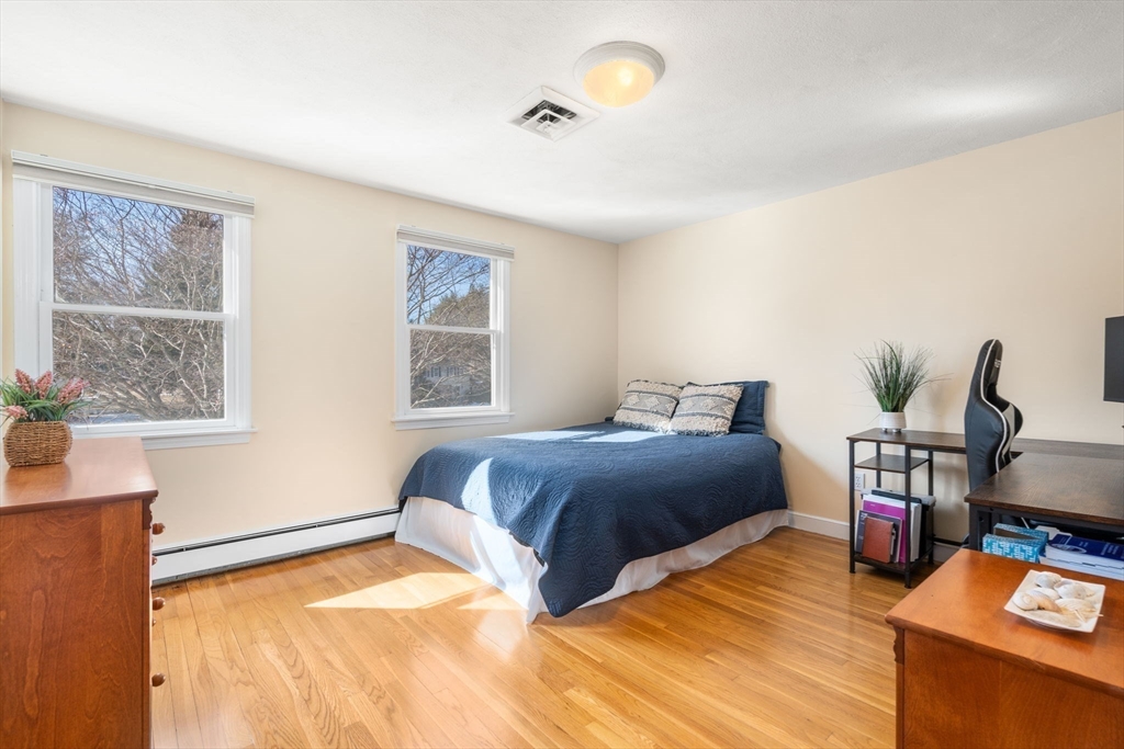 115 Victoria Road Sudbury, MA 01776 - Photo 28 of 41 a bedroom with a bed and wooden floor