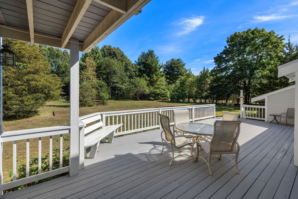115 Victoria Road Sudbury, MA 01776 - Photo 34 of 41 a view of a chairs and table on the wooden deck