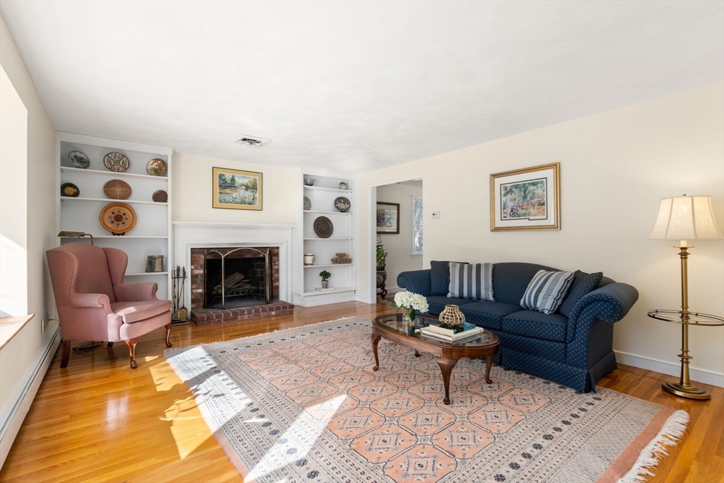 115 Victoria Road Sudbury, MA 01776 - Photo 6 of 41 a living room with furniture and a fireplace