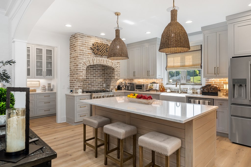 504 McCulley Road Cookeville, TN 38506 - Photo 22 of 70 a room with stainless steel appliances kitchen island granite countertop a stove a sink and a chandelier