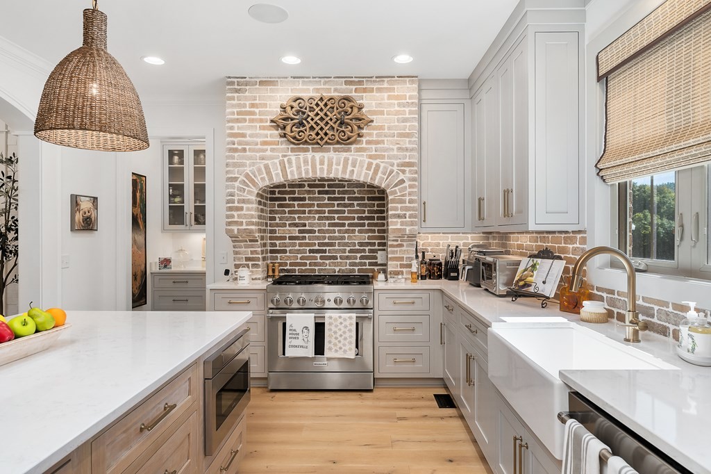 504 McCulley Road Cookeville, TN 38506 - Photo 24 of 70 a kitchen with stainless steel appliances a sink dishwasher a stove a refrigerator and a dining table with wooden floor