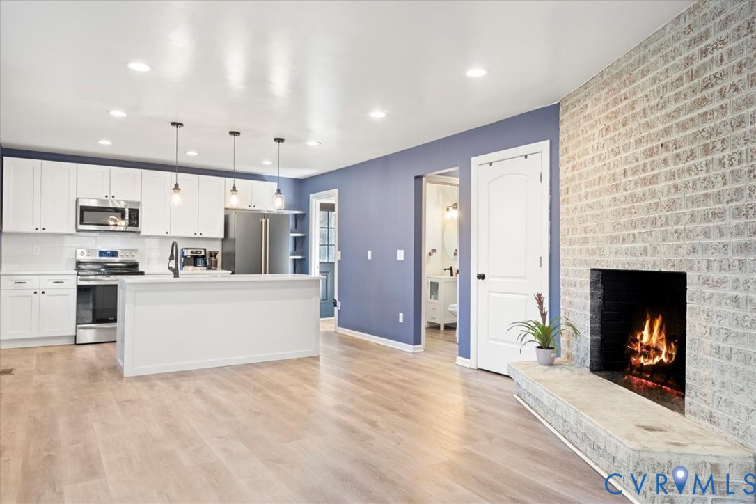 11655 Chatham Road Prince George, VA 23875 - Photo 3 of 48 a large kitchen with stainless steel appliances kitchen island granite countertop a stove top oven a sink and a refrigerator