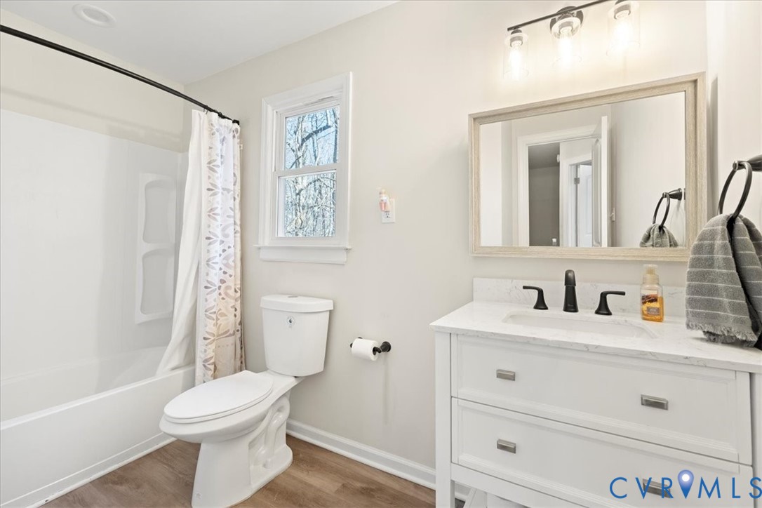 11655 Chatham Road Prince George, VA 23875 - Photo 37 of 48 a bathroom with a toilet a sink a mirror a bathtub and shower